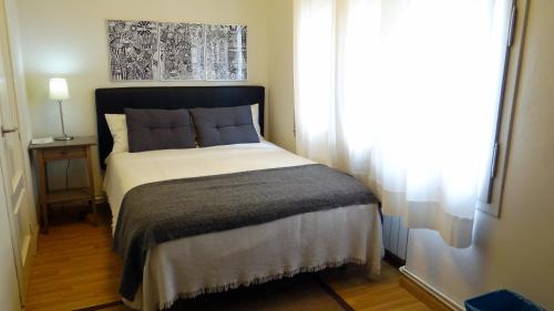 
a bed room with a white bedspread and pillows at Hostal El Ninot in Barcelona
