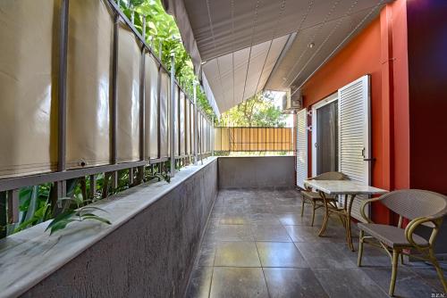 a corridor of a building with tables and chairs at Alexia's Apartments in Rio