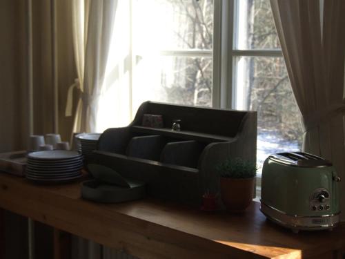 a kitchen counter with a sink and a window at Skålleruds Gård in Åsensbruk