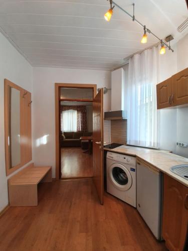 a kitchen with a washer and dryer in it at Sophia Guesthouse in Adler