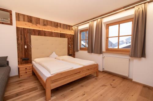 a bedroom with a bed and a window at Sennerhof in Racines