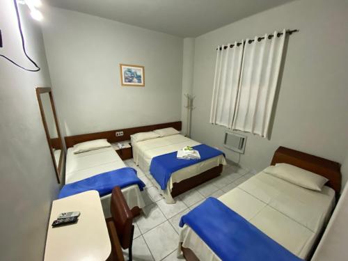 Caiçara Hotel tesisinde bir odada yatak veya yataklar