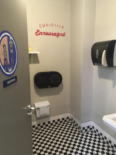 a bathroom with a sign on the door and a toilet at HI San Diego Downtown Hostel in San Diego