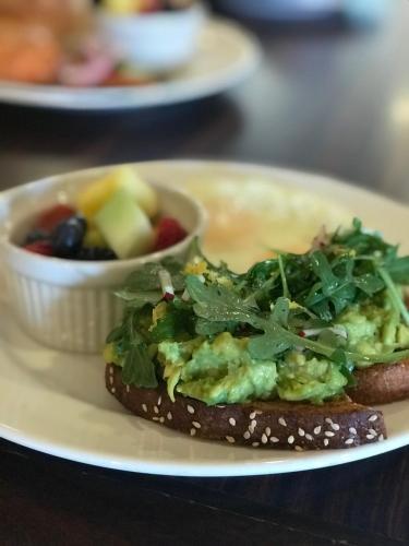 a plate with a sandwich and a bowl of fruit at Red Mountain Resort in St. George