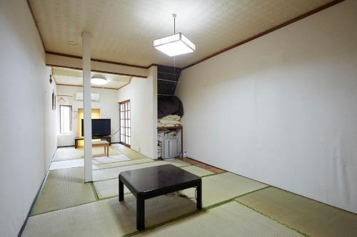 a room with a table in the middle of a room at Iruka House 1 - Vacation STAY 9266 in Iki