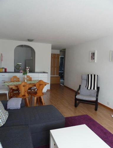 a living room with a couch and a table at Eldorado 44 in Leukerbad