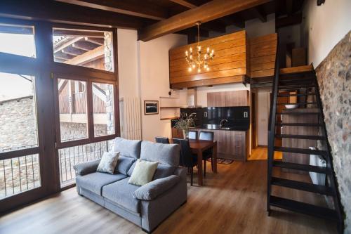 a living room with a couch and a dining room at El Paller de Casa Parramon in Peramea