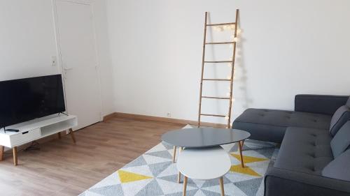 a living room with a couch and a table at Appart hôtel plage des capucins in La Ciotat