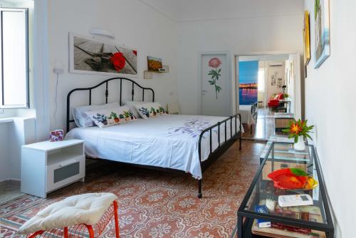 a bedroom with a bed and a glass table at Casa Dreaming Ortigia in Siracusa