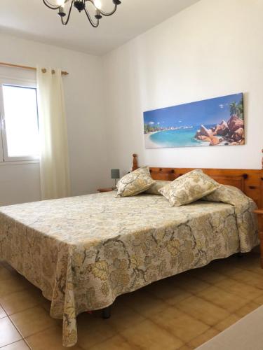 1 dormitorio con 1 cama y una pintura en la pared en Lanzarote - El Golfo, en El Golfo