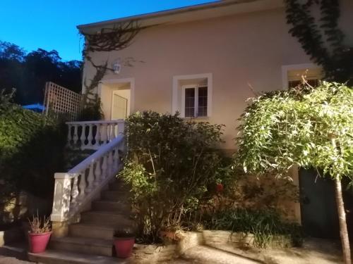 a house with stairs and trees in front of it at Suite de charme avec JACUZZI illimité et jardin privatif in Saint-Prix