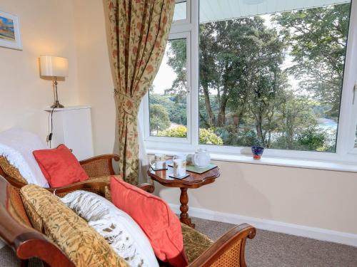 a living room with a couch and a window at Sunrise, 8 Melbury in Salcombe