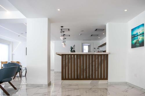 a bar in a room with white walls and chairs at Best Western Plus Larco Hotel in Larnaka