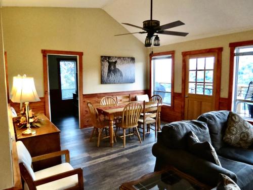 a living room with a couch and a table and chairs at Million Dollar Views! 4 Bedroom, Sleeps 9, close to National Park and 5 mi to Gatlinburg! in Gatlinburg