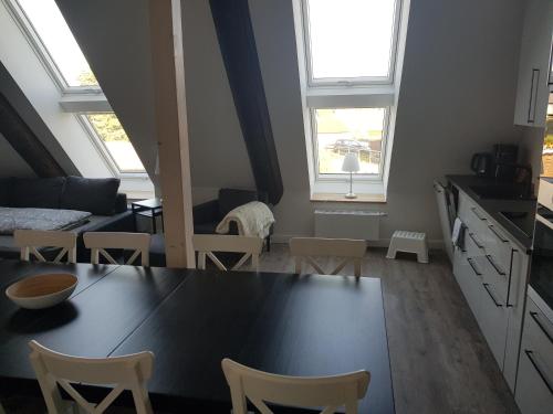a kitchen and living room with a table and chairs at Hausdeich in Hamburg