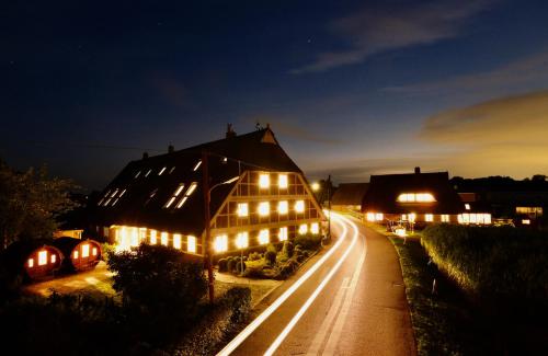 a large house with lights on a street at night at Hausdeich in Hamburg
