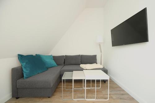 a living room with a couch and a tv at Hausdeich in Hamburg