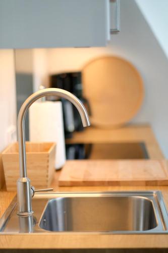 a stainless steel sink in a kitchen with a counter at Hausdeich in Hamburg