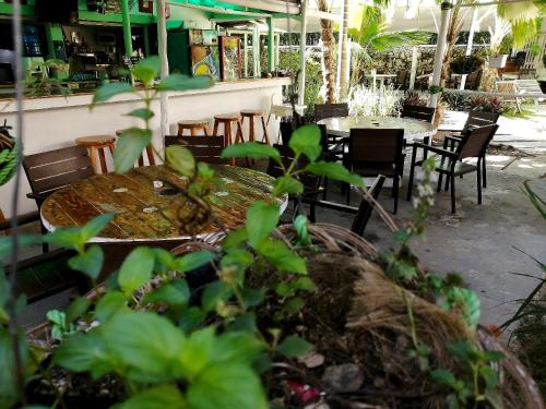 a patio with a table and chairs and plants at Riviera Punta Cana Eco Travelers in Punta Cana