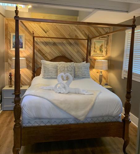 a bedroom with a bed with a stuffed animal on it at Peace & Plenty Inn Bed and Breakfast Downtown St Augustine-Adults Only in Saint Augustine
