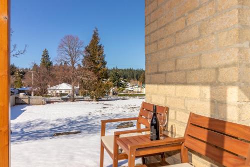 a wooden bench sitting next to a brick wall at NASEBY lodge in Naseby