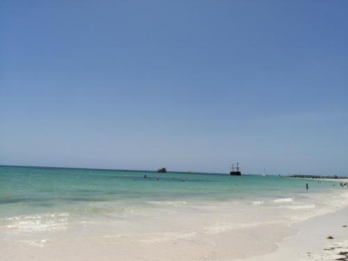 a group of people in the water at the beach at Riviera Punta Cana Eco Travelers in Punta Cana