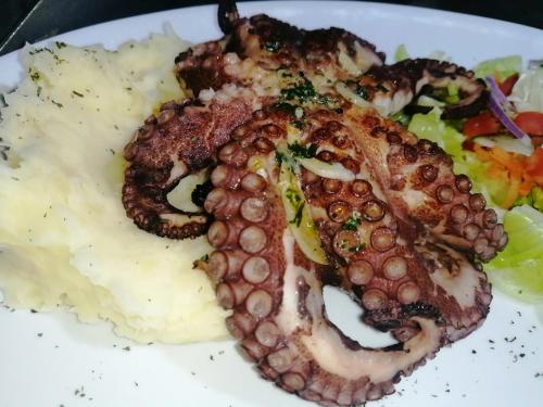 a plate of food with meat and mashed potatoes and vegetables at Riviera Punta Cana Eco Travelers in Punta Cana
