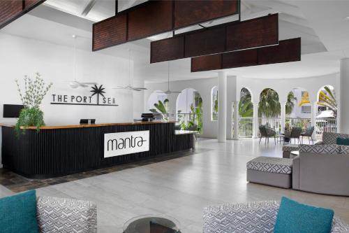 
a living room filled with lots of furniture at Mantra PortSea in Port Douglas
