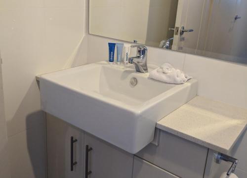 a white sink in a bathroom with a mirror at Blues Air 3 in Thredbo