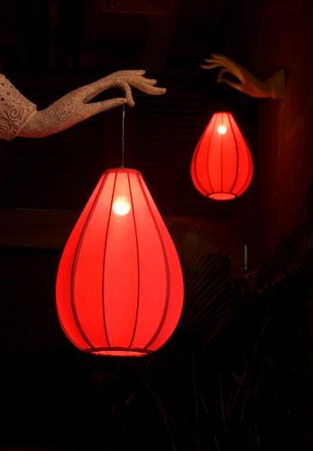 a group of red lanterns hanging from a wall at Lan Kwai Fong Hotel - Kau U Fong in Hong Kong