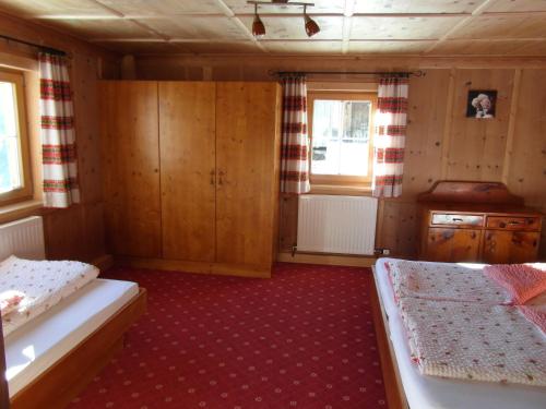 a small room with two beds and a kitchen at Ferienhaus Nadine in Kappl