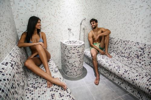 a man and a woman sitting on a bath tub at Hotel Centar No.1 in Belgrade