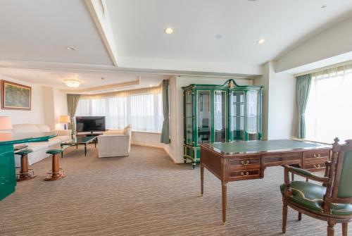 a hotel room with a pool table and a room with at Resol no Mori in Nagara