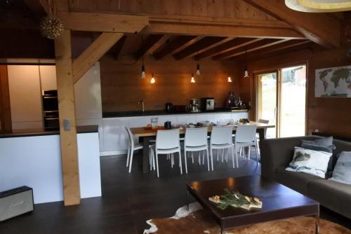 a kitchen and living room with a couch and a table at Grand chalet Le Trappeur - Chamonix in Chamonix