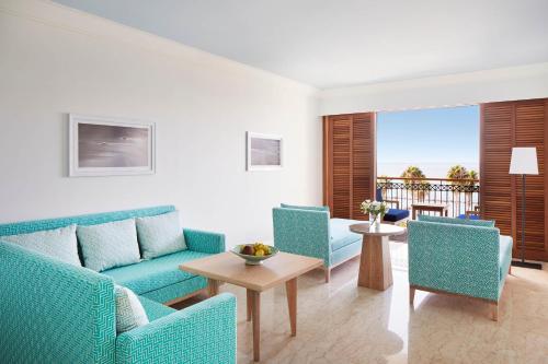 
a living room filled with furniture and a blue couch at Annabelle in Paphos
