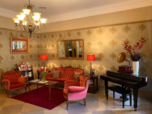 a living room with a couch and a piano at Bli Bli House Riverside Retreat in Twin Waters