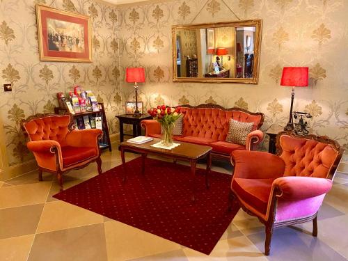 a living room with a couch and chairs and a table at Bli Bli House Riverside Retreat in Twin Waters