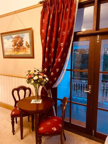 a room with a table and chairs and a window at Bli Bli House Riverside Retreat in Twin Waters