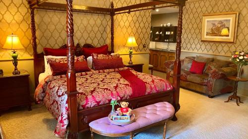 a bedroom with a bed with a doll sitting on a bench at Bli Bli House Riverside Retreat in Twin Waters