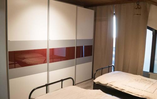 a bedroom with two beds and a large cabinet at Work & stay Vohburg near Ingolstadt in Vohburg an der Donau