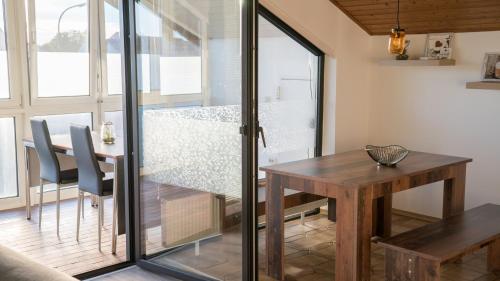 a dining room with a table and a glass door at Work & stay Vohburg near Ingolstadt in Vohburg an der Donau
