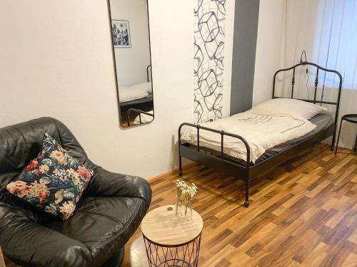 a living room with a couch and a bed at Work & stay Vohburg near Ingolstadt in Vohburg an der Donau