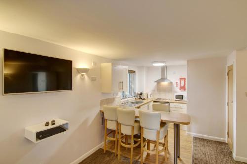 a kitchen with a table and chairs and a sink at China Fleet Country Club in Saltash