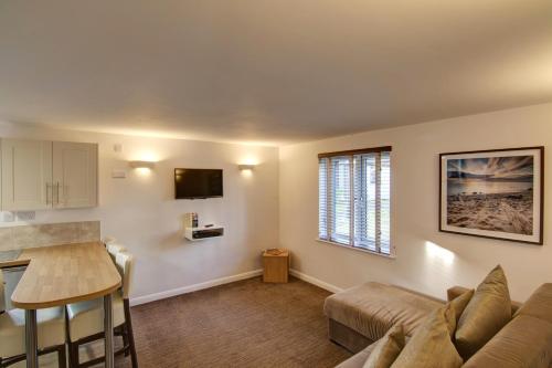a living room with a couch and a table at China Fleet Country Club in Saltash