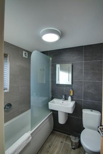 a bathroom with a sink and a toilet and a shower at China Fleet Country Club in Saltash