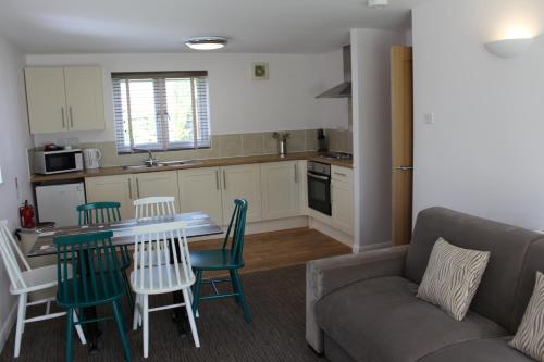 a kitchen and living room with a couch and a table at China Fleet Country Club in Saltash