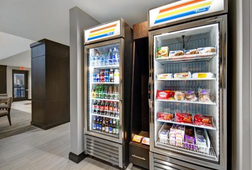 a refrigerator with its door open with food and drinks at Staybridge Suites Sterling Heights - Detroit by IHG in Sterling Heights