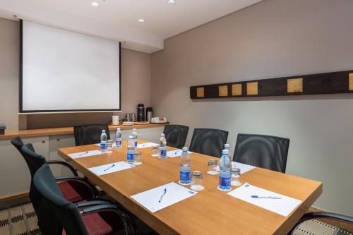 a conference room with a table and chairs with water bottles at Holiday Inn Express Cape Town City Centre by IHG in Cape Town