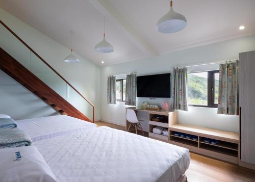 Postel nebo postele na pokoji v ubytování 名竹旅社 Minzu Hotel