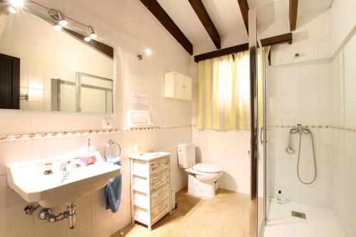 a bathroom with a sink and a toilet and a shower at El Bikoro in Port de Pollensa